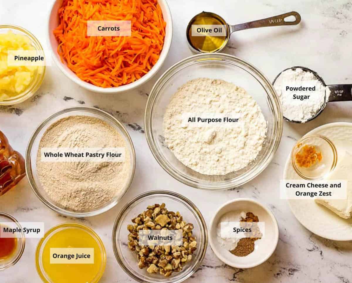 Ingredients for vegan carrot cake recipe on a white background.