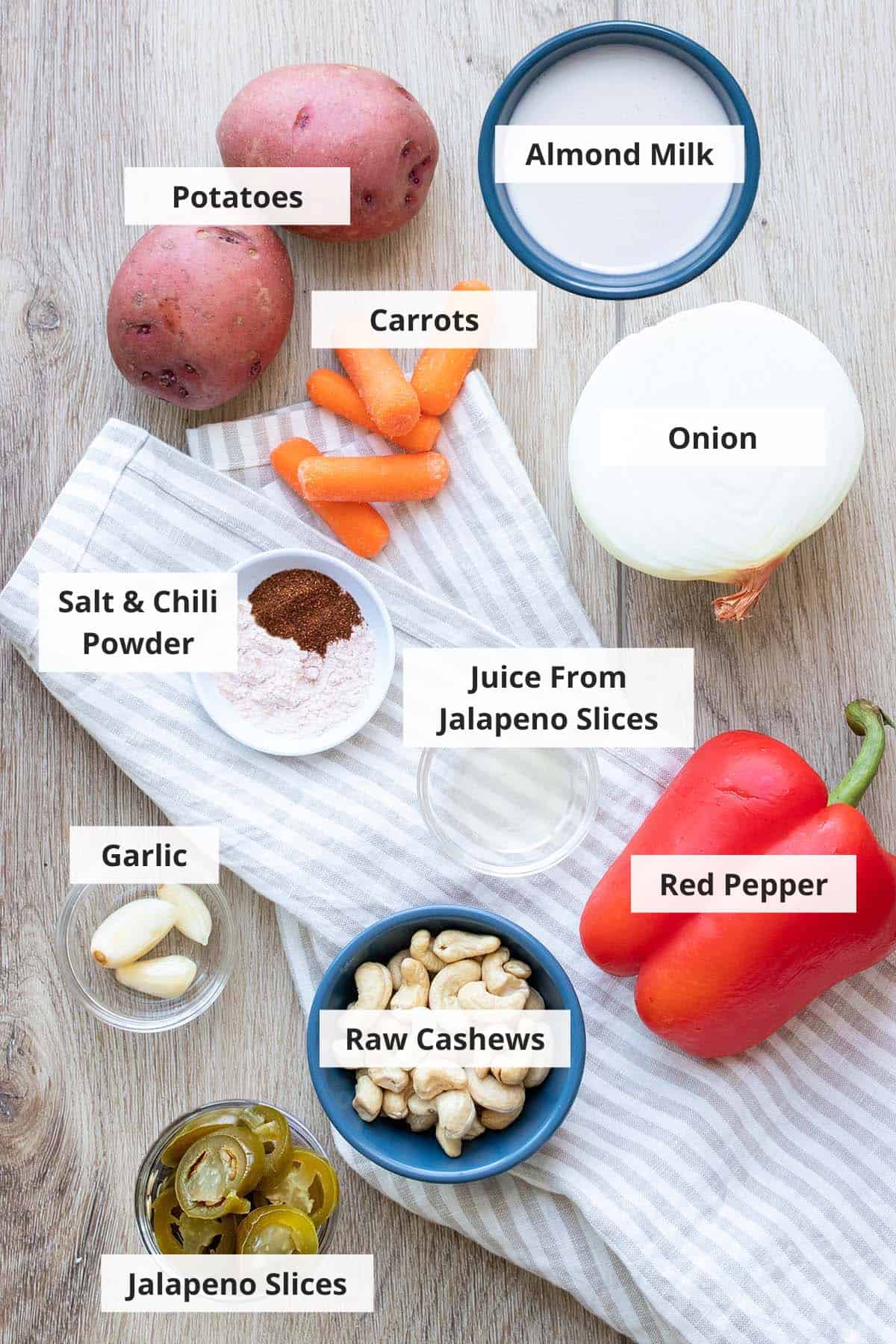 Ingredients for vegan nacho cheese sauce recipe on a wood background.