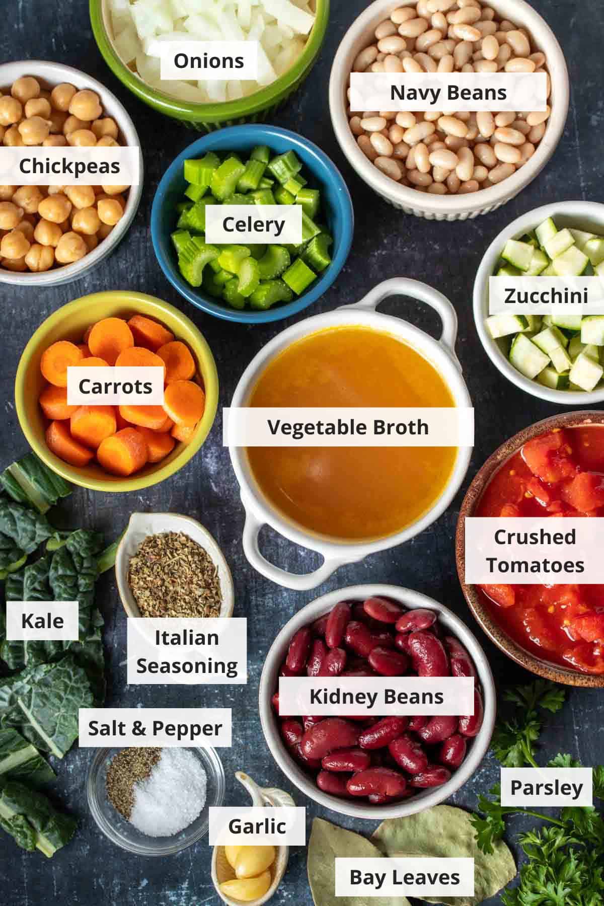 Ingredients for vegetable bean soup on a black background.