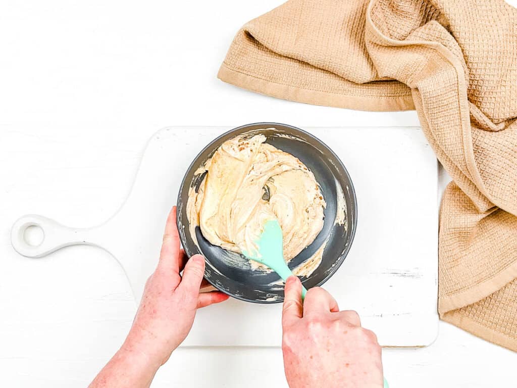 Sour cream and spices mixed in a bowl.