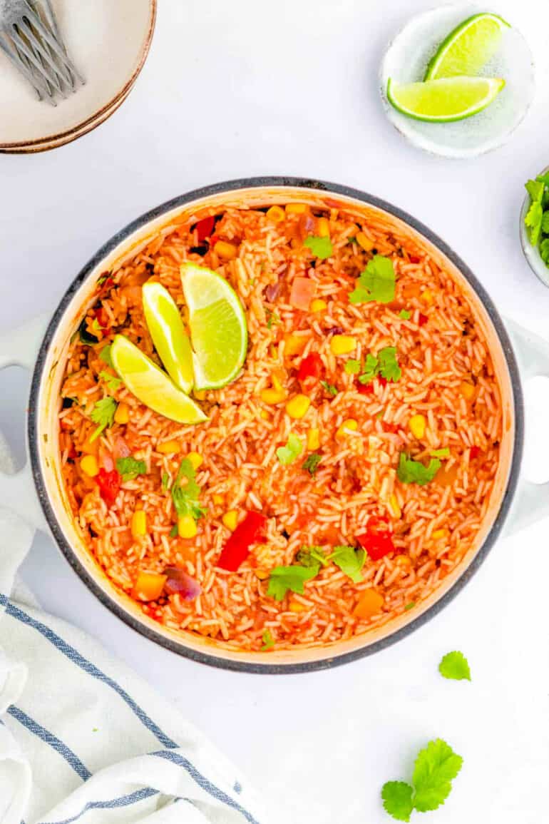 Easy vegan Mexican rice recipe in a stock pot, garnished with lime.
