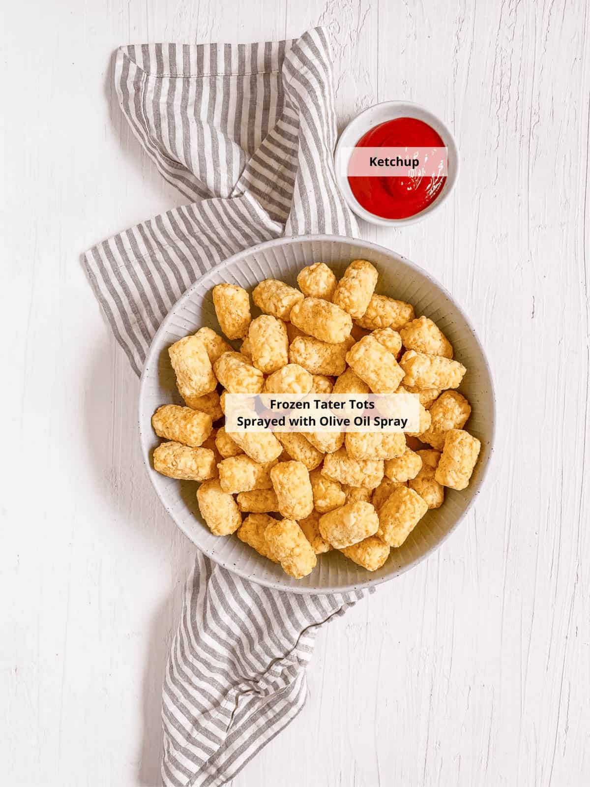 Ingredients for air fryer frozen tater tots recipe on a white background.
