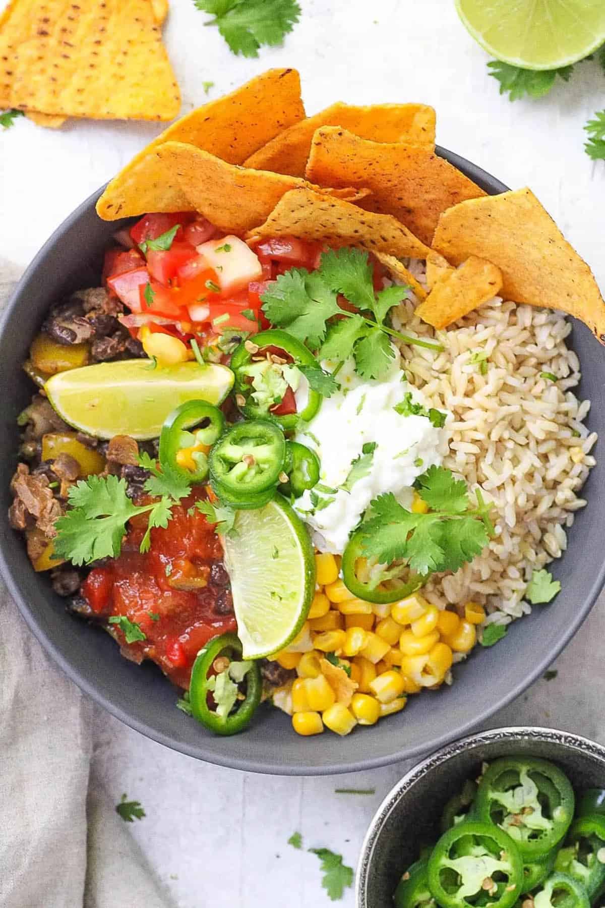 vegan burrito bowl served with tortilla chips on the side.