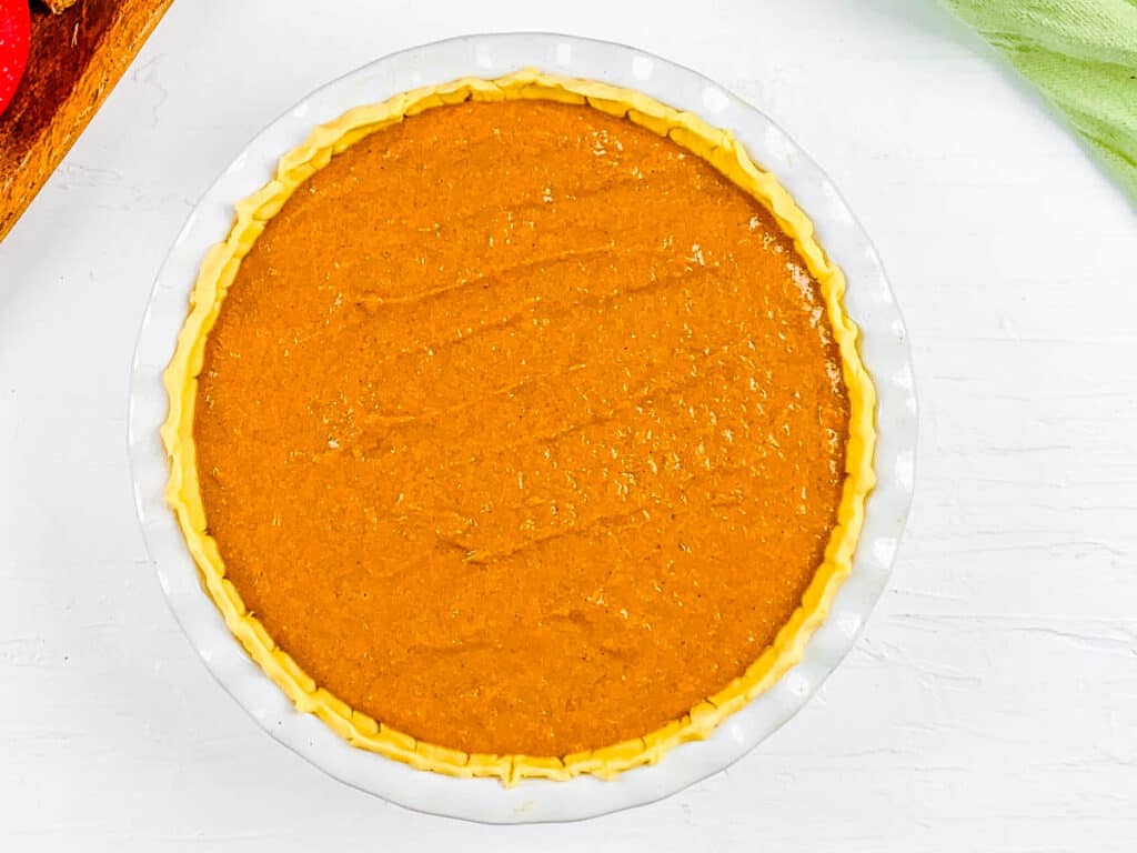 Pumpkin and apple pie in a baking dish, ready to go into the oven.