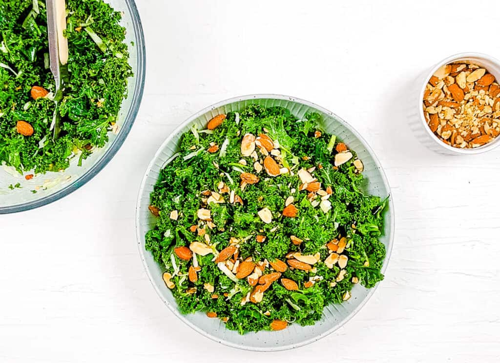 Chick-Fil-A kale crunch salad recipe served in a white salad bowl, garnished with almonds, top view.