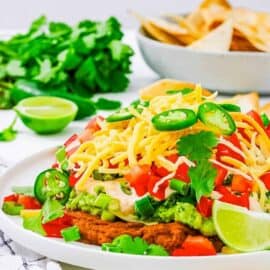 Easy, healthy 7 layer taco dip served on a white plate.