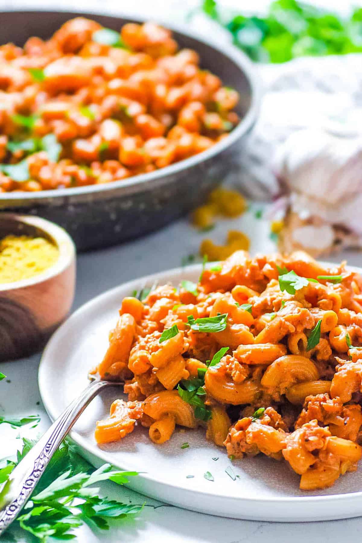 Close up side shot of a white plate of vegan hamburger helper.