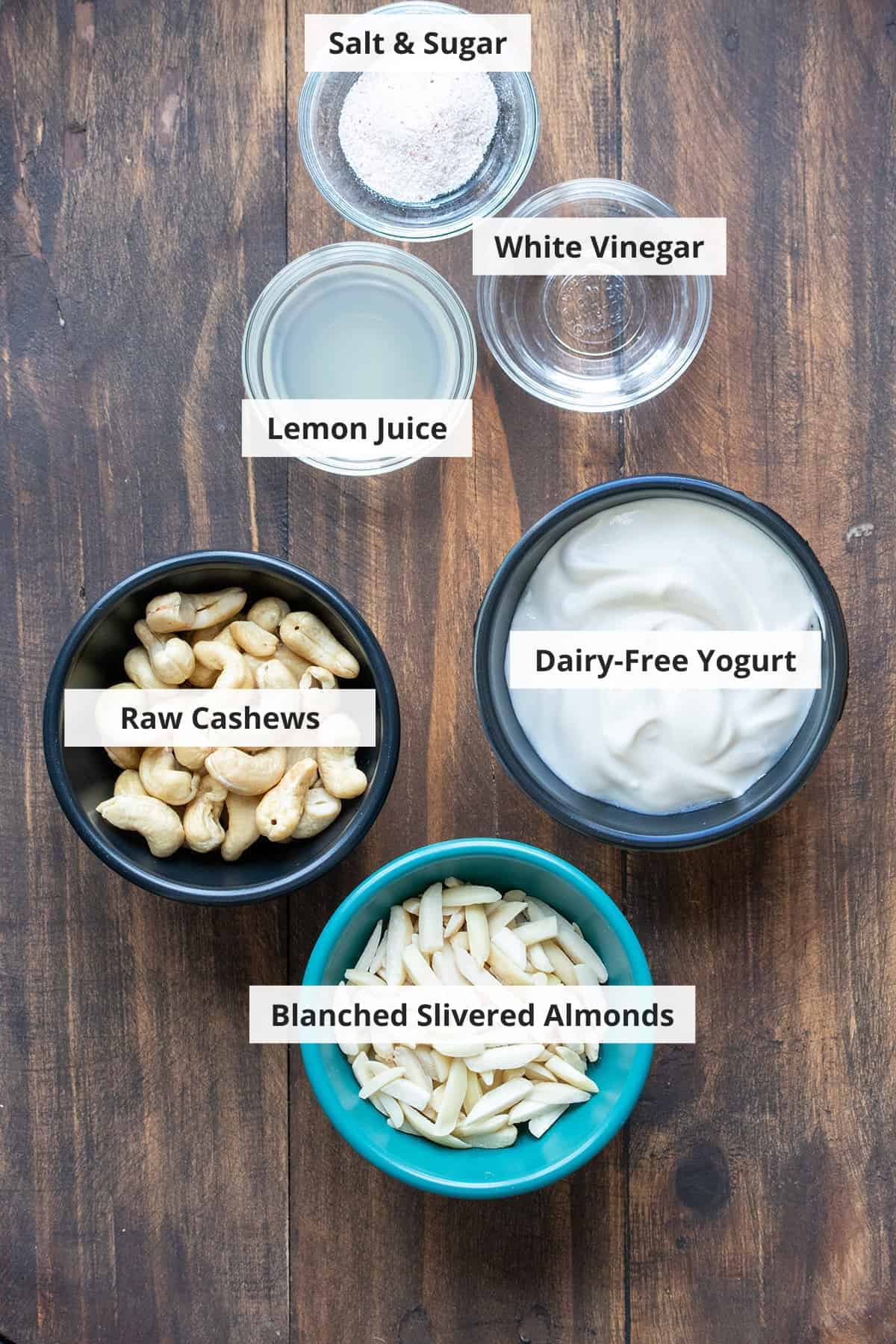 Ingredients for vegan mascarpone recipe on a wood background.