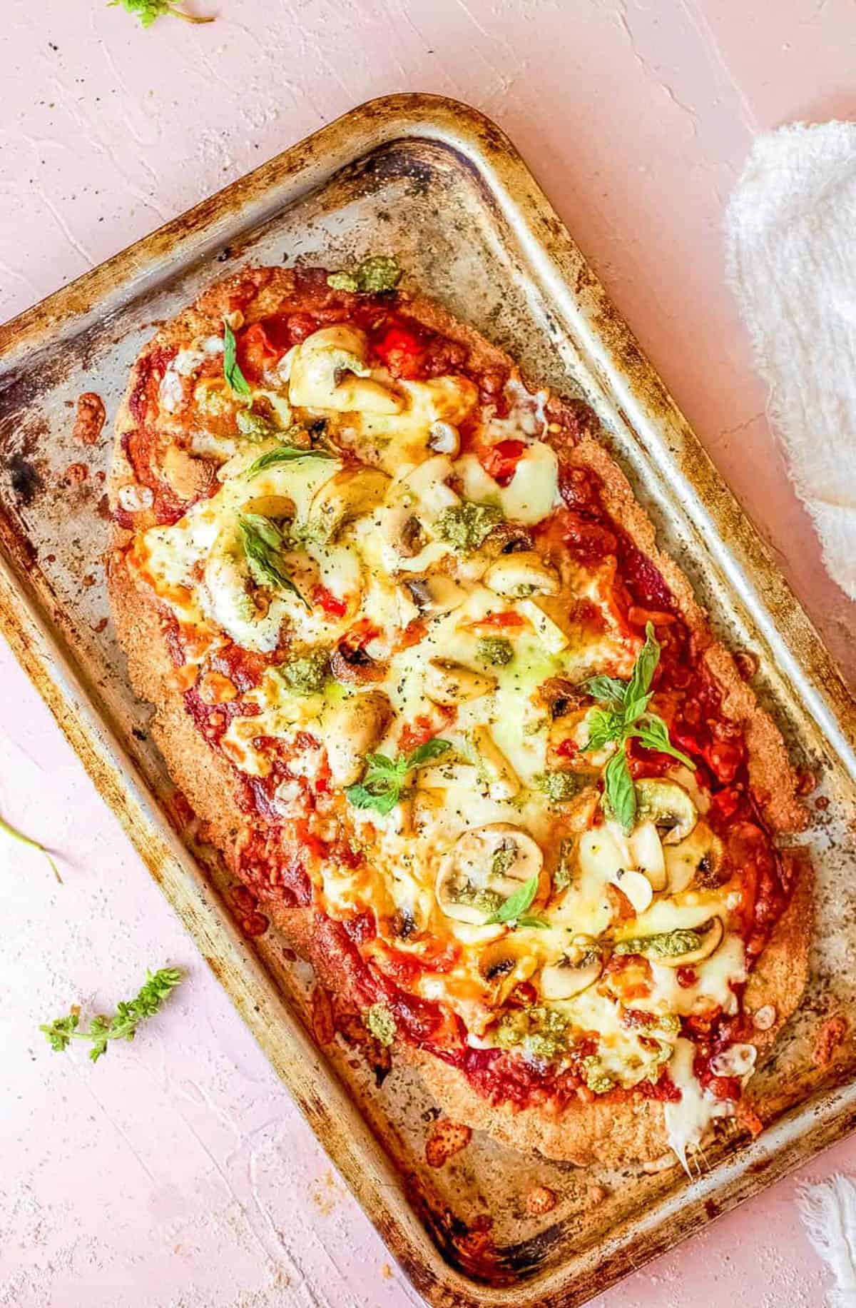 Vegan mushroom flatbread on a baking sheet.