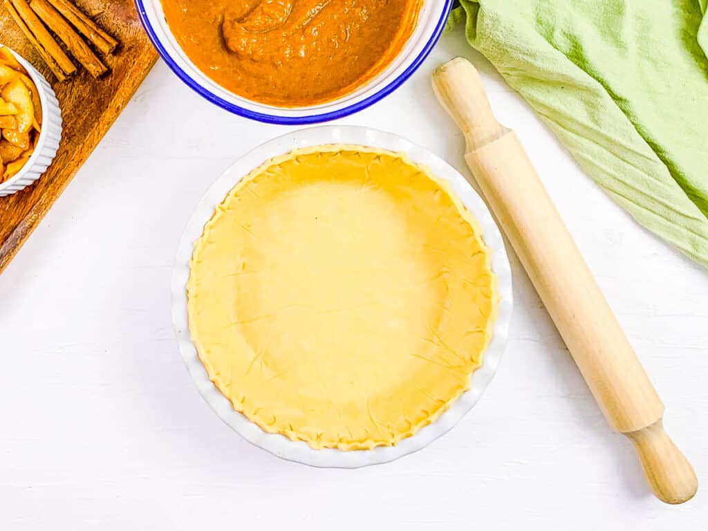 Pie crust for apple pumpkin pie placed in a pie baking dish.