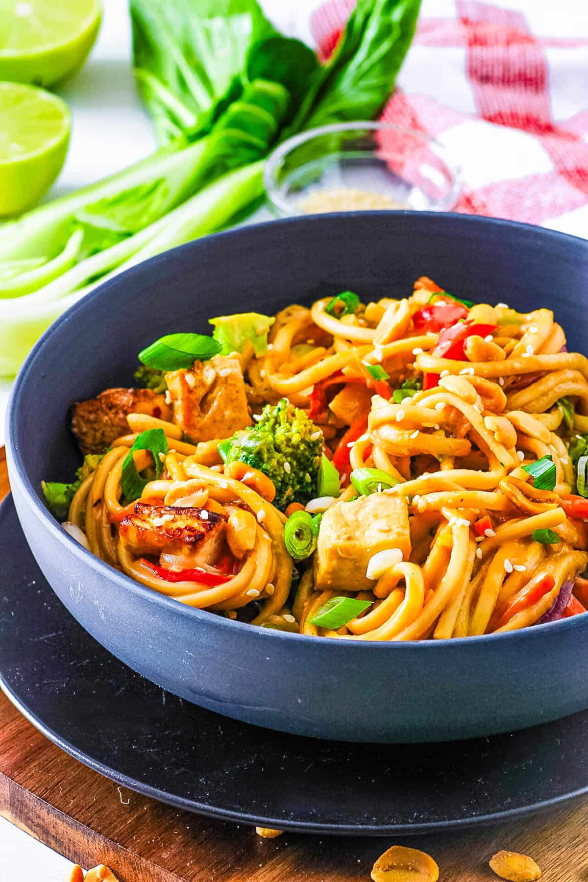 Vegan peanut noodles tossed with veggies and tofu in a bowl.