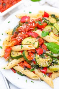 Easy vegan pasta primavera served on a white plate.