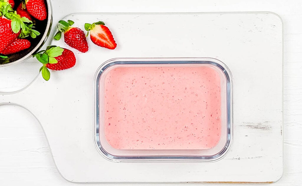 Homemade healthy strawberry yogurt, stored in a glass container.