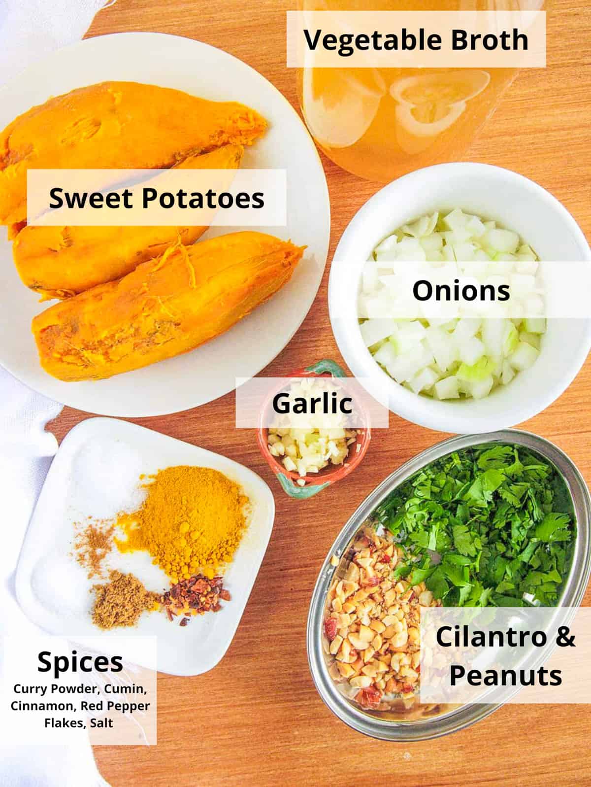 Ingredients for curried sweet potato soup recipe on a wooden cutting board.