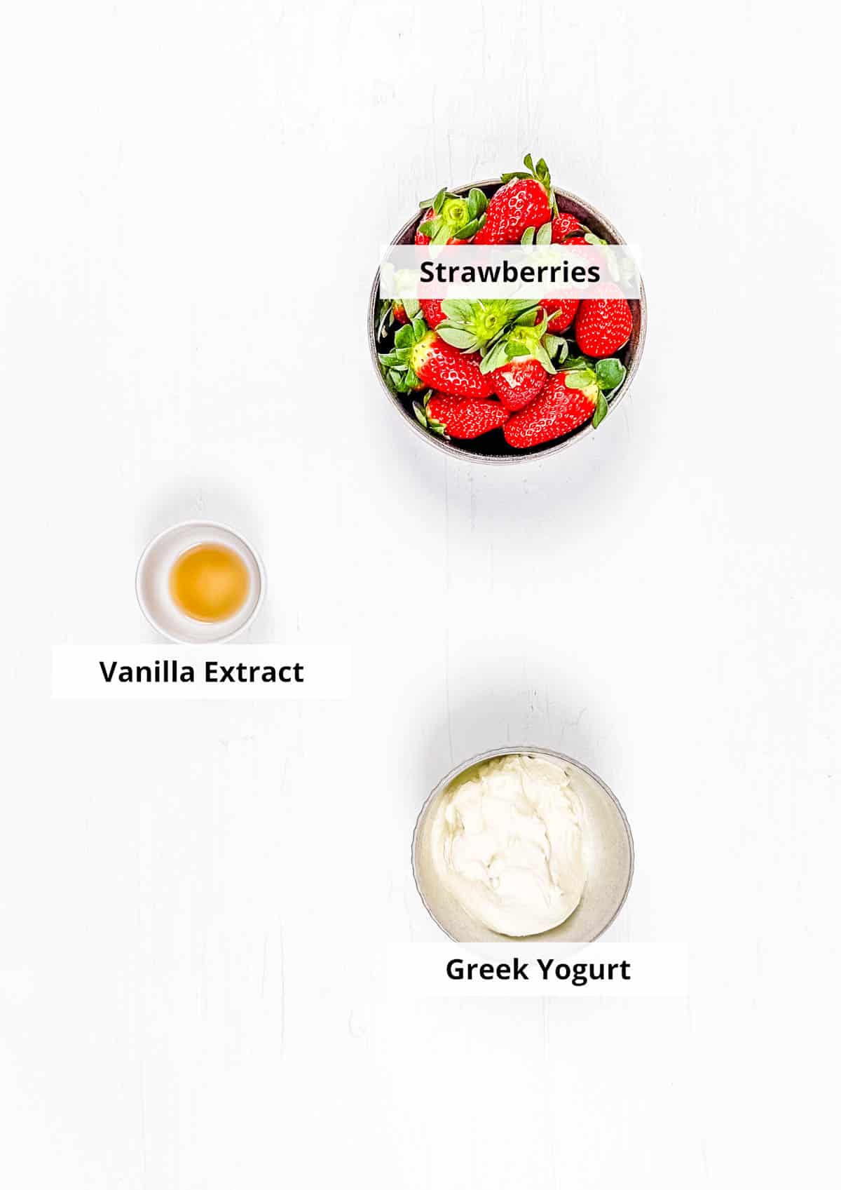 Ingredients for homemade strawberry yogurt recipe on a white background.
