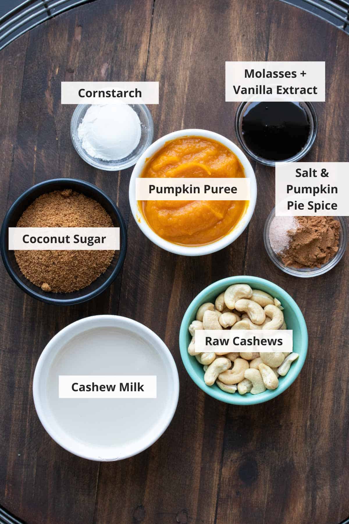 Ingredients for gluten free vegan pumpkin pie recipe on a wood background.