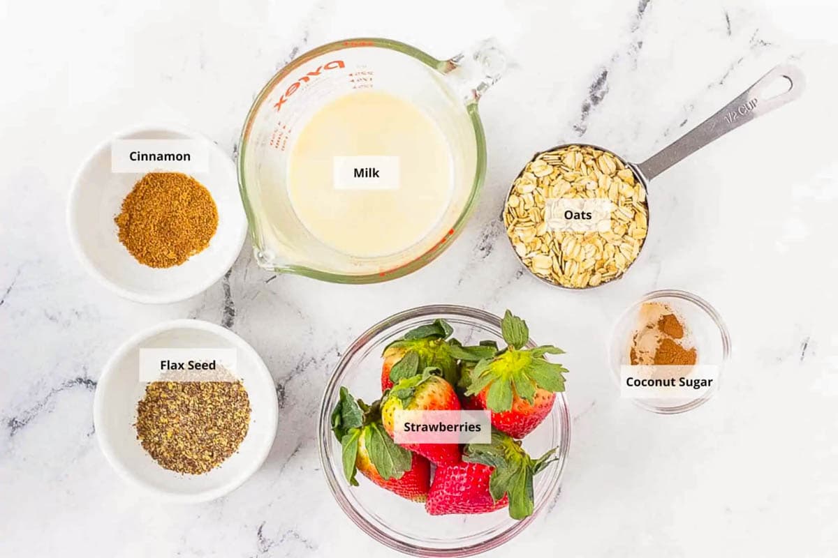 Ingredients for strawberries and cream oatmeal recipe on a white background.