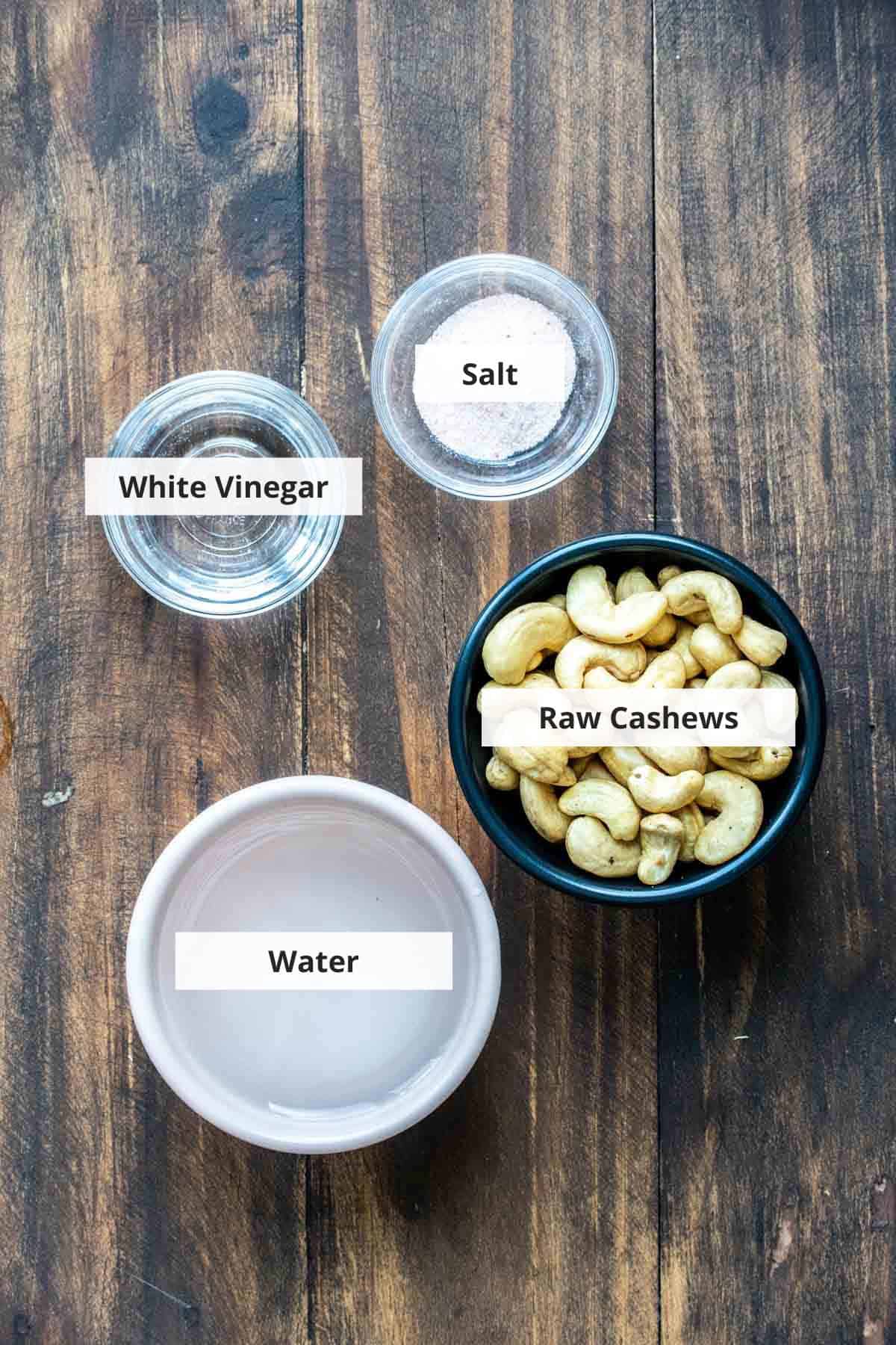 Ingredients for vegan feta cheese recipe on a wood background.