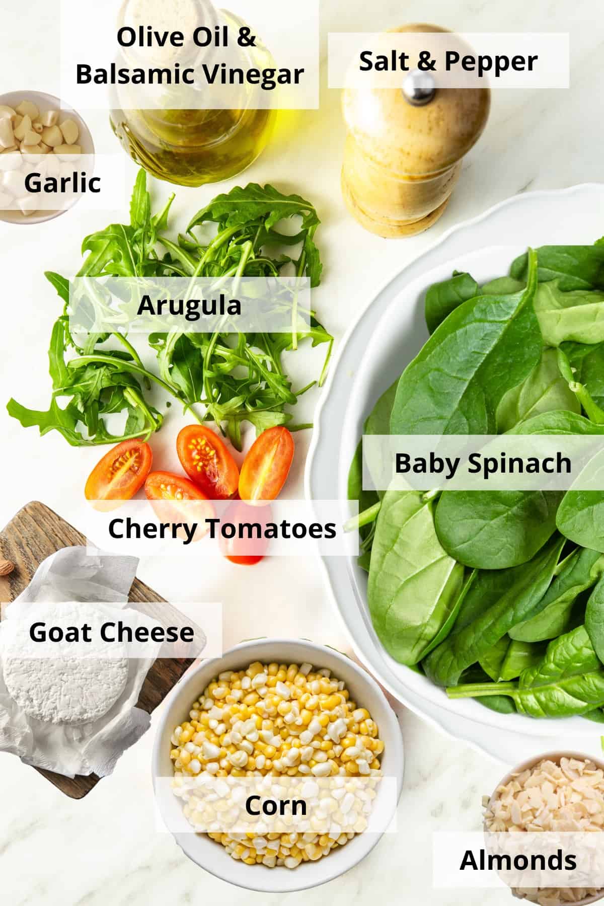 Ingredients for spinach and arugula salad recipe on a white background.