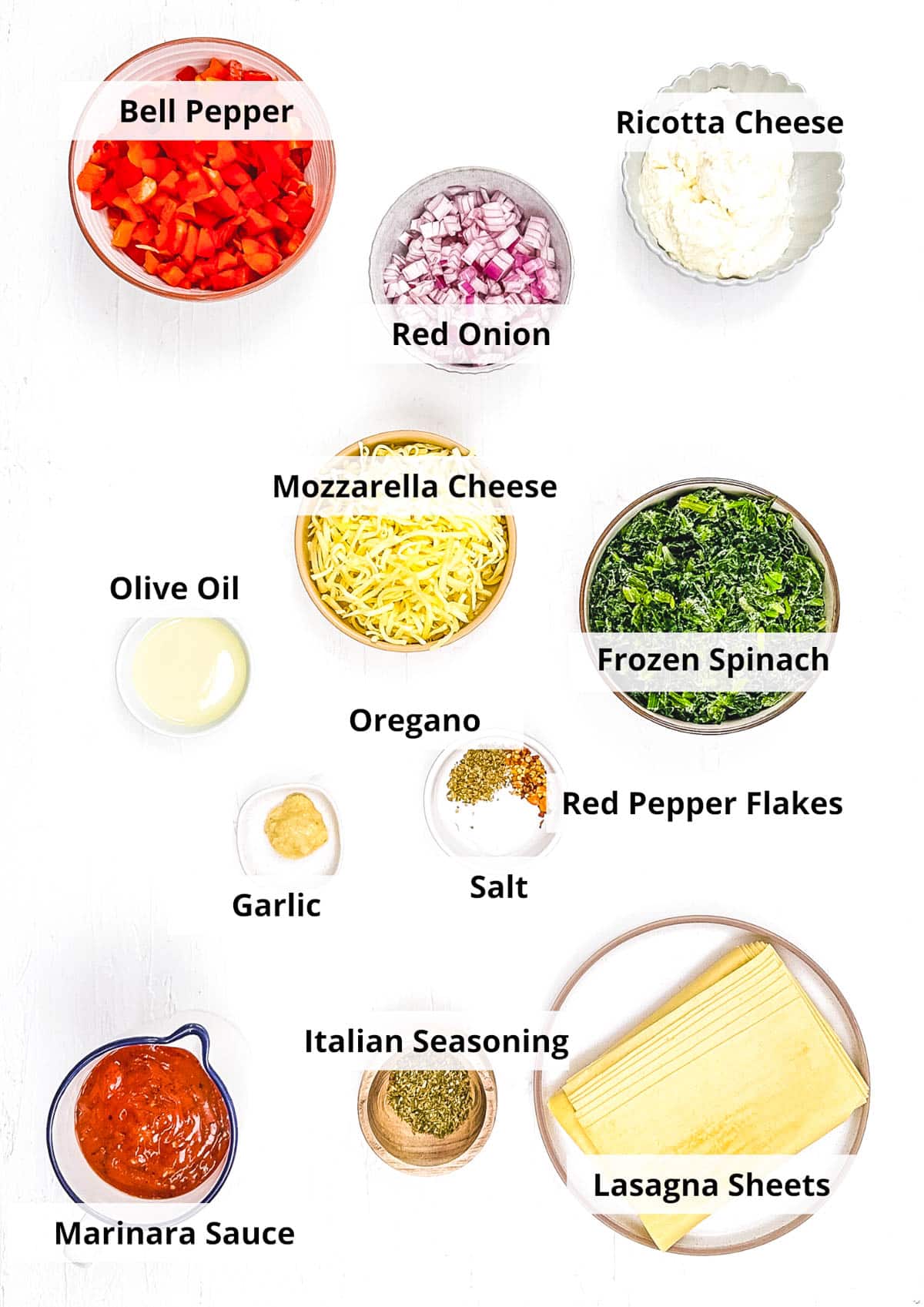 Ingredients for vegetarian lasagna roll ups on a white background.