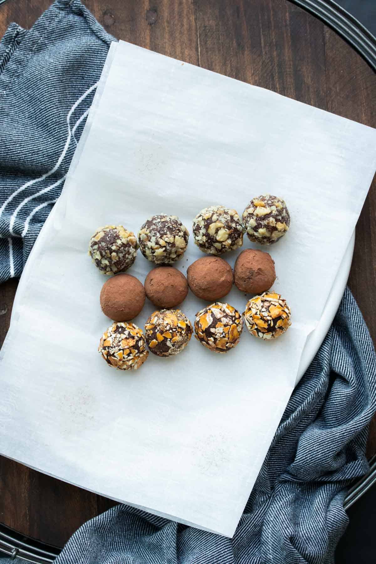 Rows of chocolate truffles rolled in different toppings.