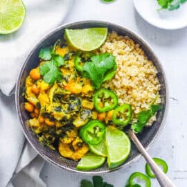 Easy vegan Thai green curry recipe served with quinoa in a black bowl.