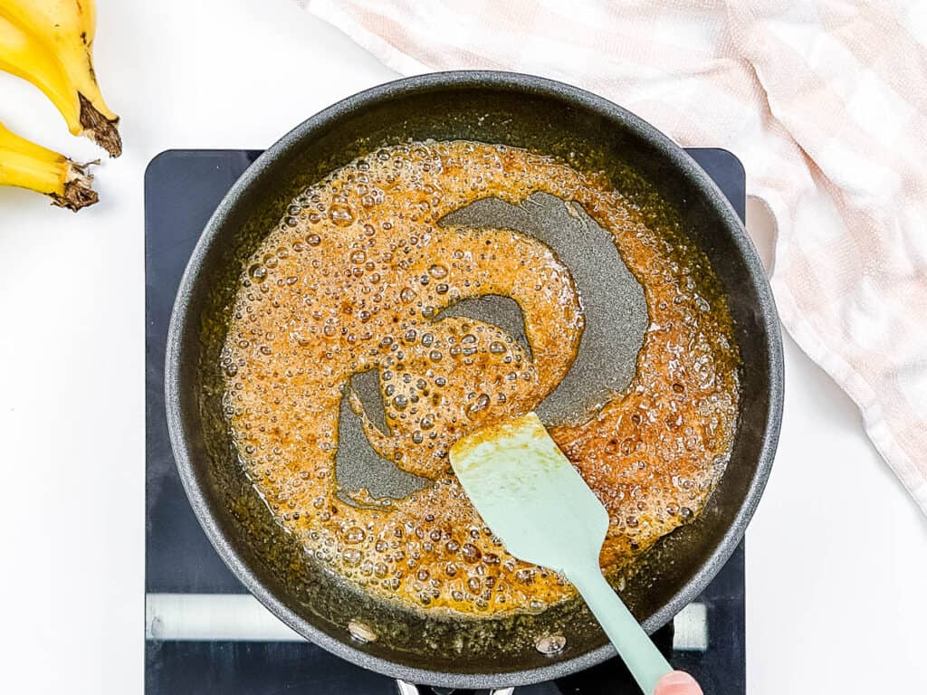 Brown sugar and ،er sauteeing in a pan.