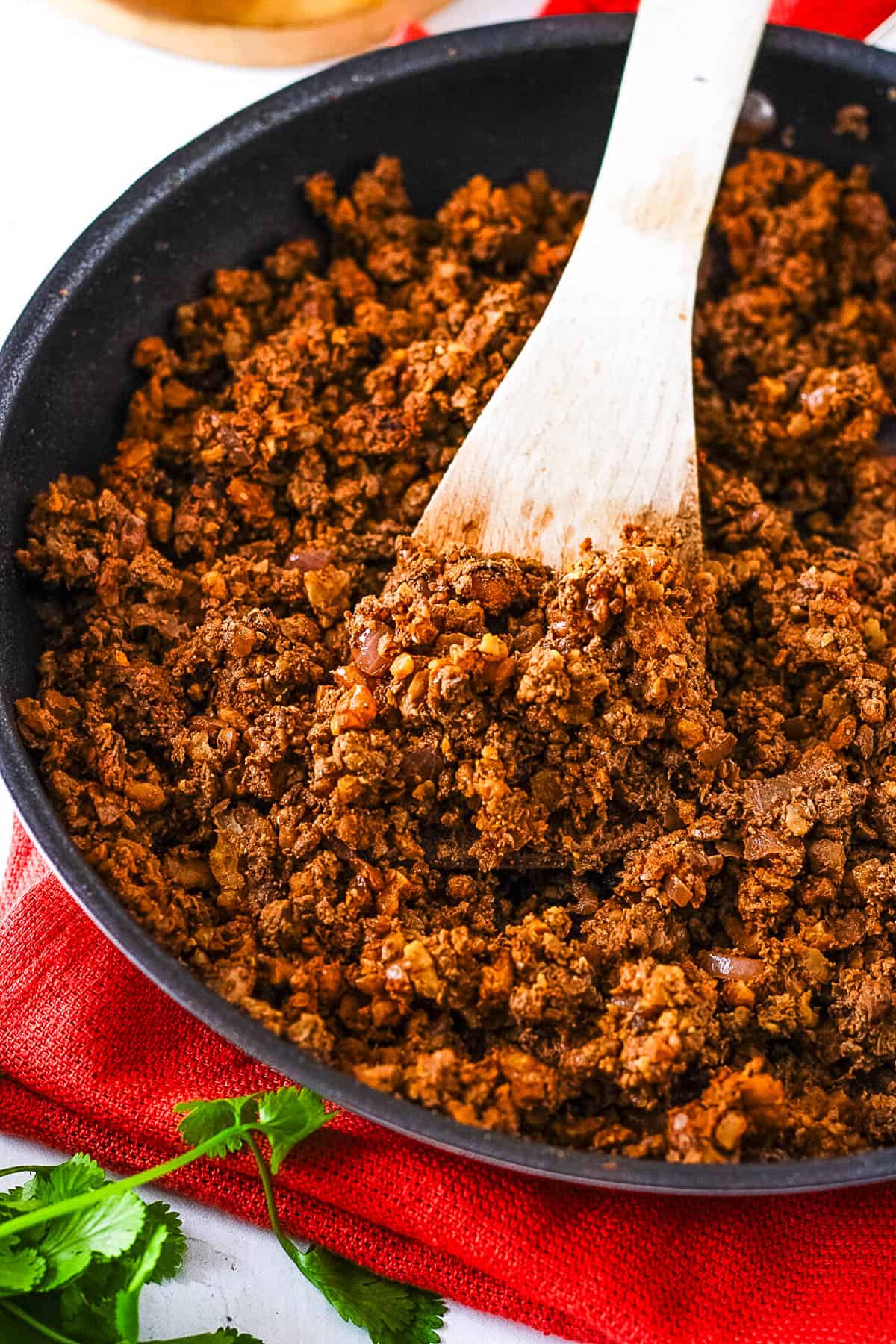 Healthy walnut taco meat, served in a large s،et with a wooden s،.