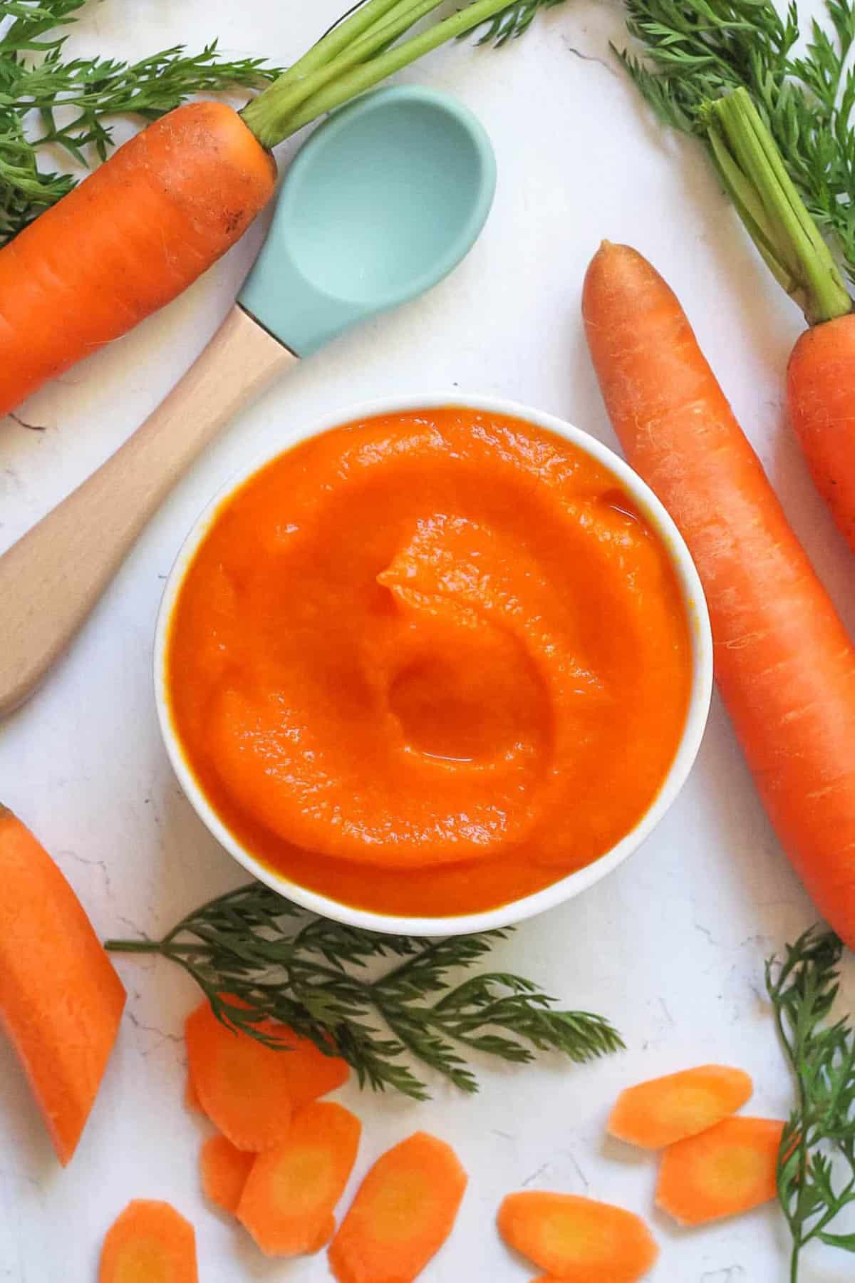 Carrot baby food puree in a white bowl.
