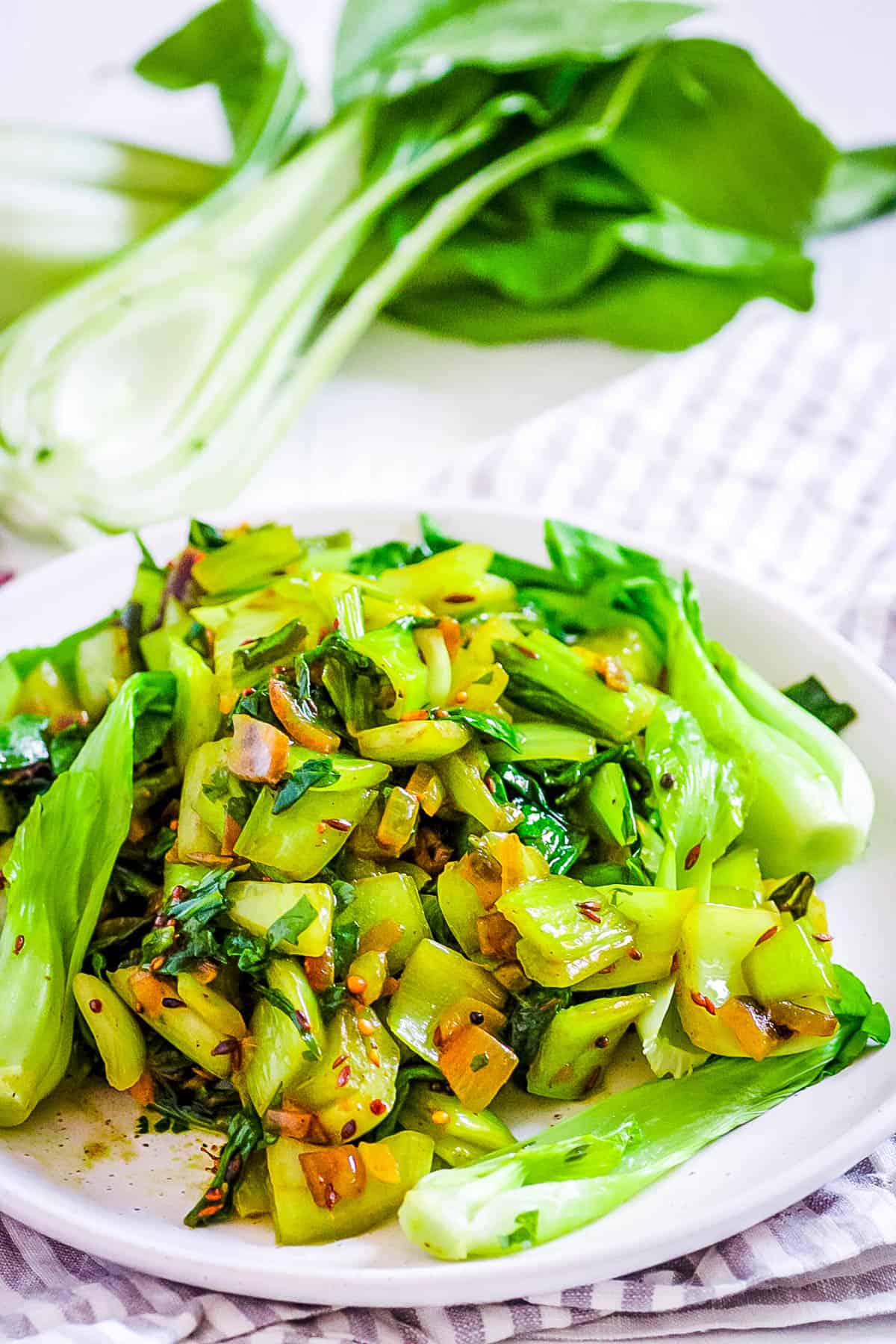 Indian bok choy stir fry served on a white plate.