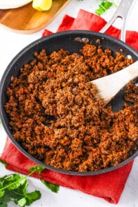 Walnut taco meat, served in a large skillet with a wooden spoon.