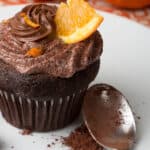 Chocolate orange frosting on a chocolate cupcake.