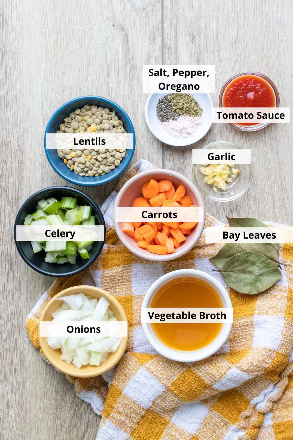 Ingredients for Greek lentil soup on a grey background.