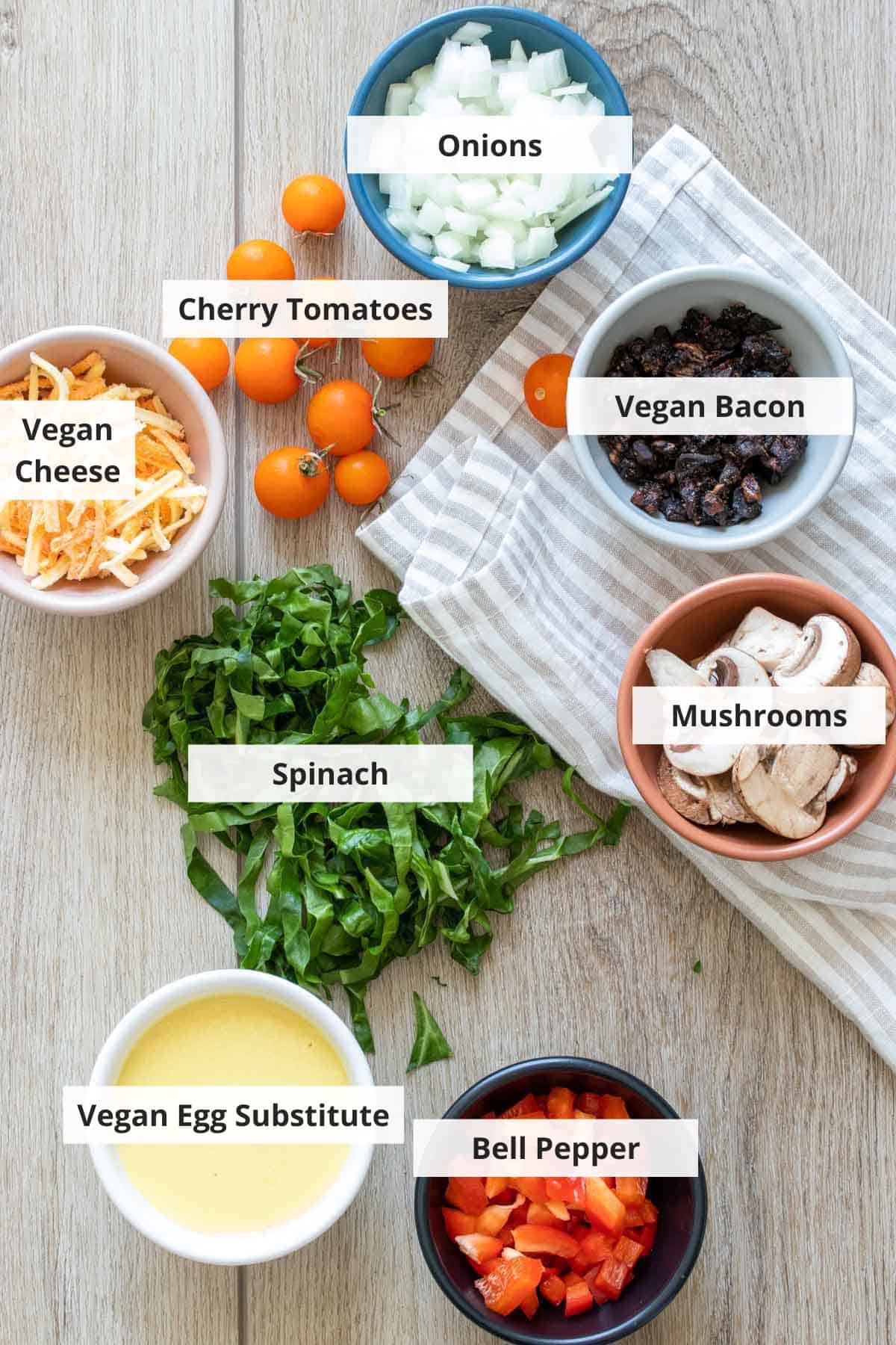 Ingredients for vegan omelette recipe on a wood countertop.