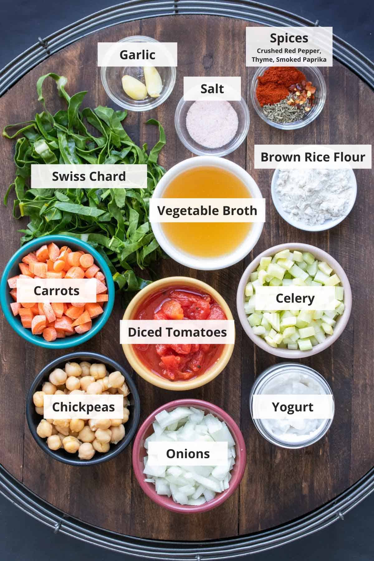 Ingredients for 30 minute chickpea and tomato stew on a wood background.