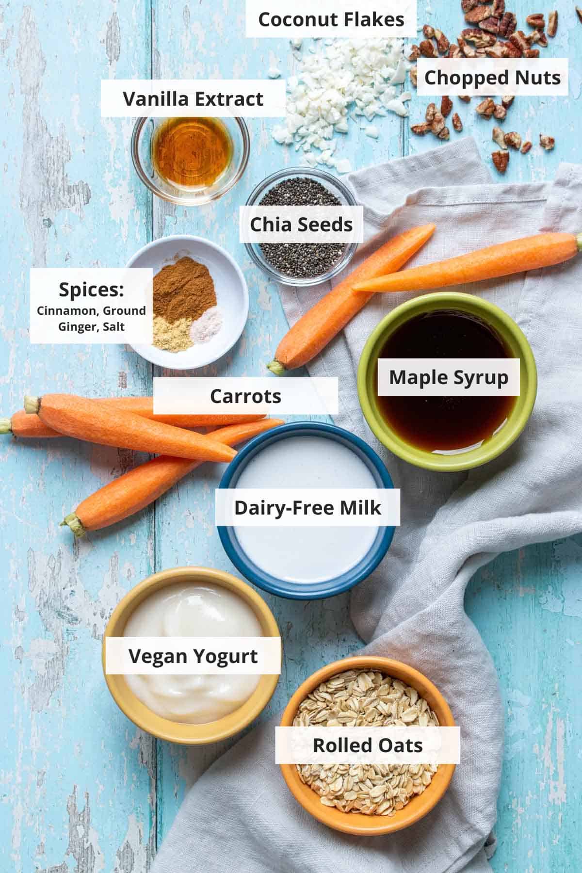 Ingredients for vegan carrot cake overnight oats on a blue wood background.