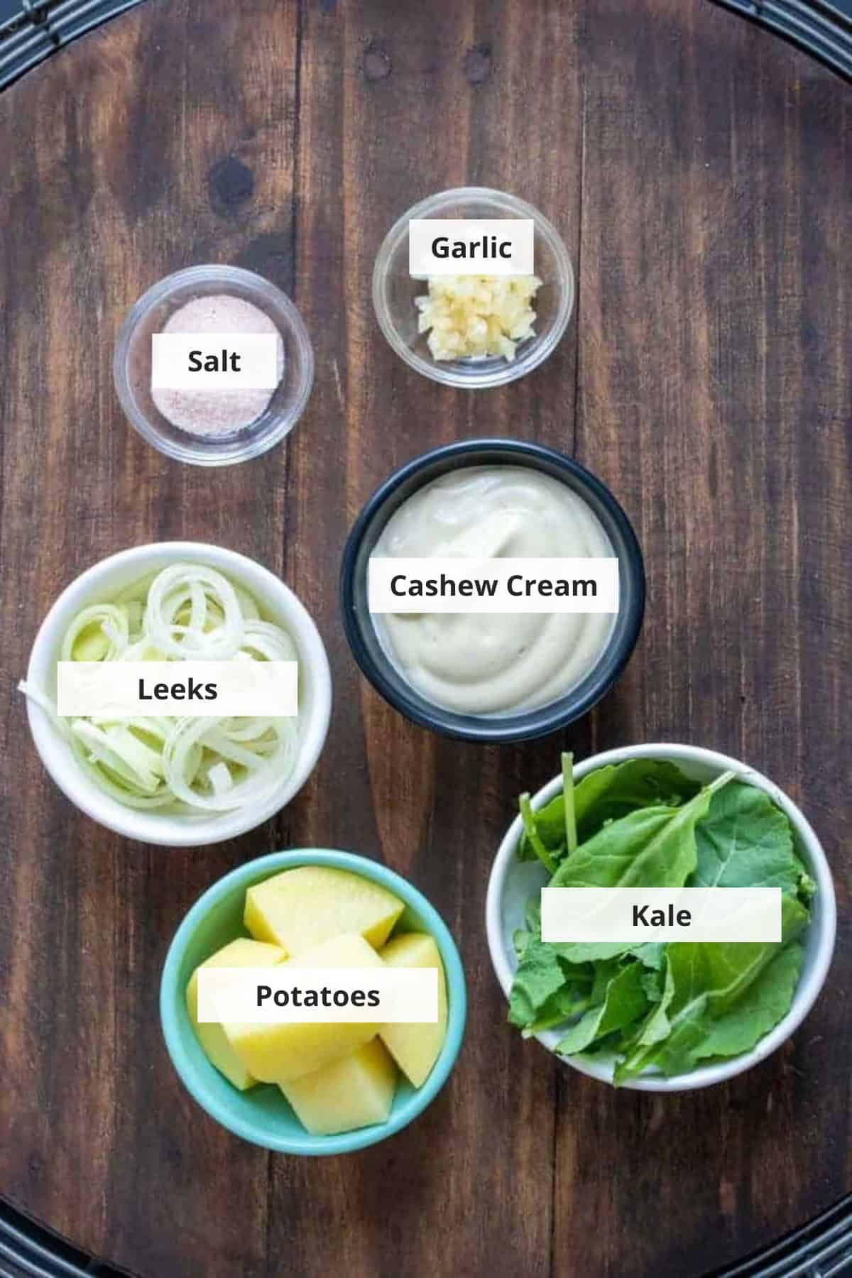 Ingredients for vegan colcannon potatoes recipe on a wood background.