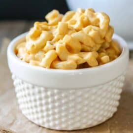 Creamy vegan cheese sauce without nutritional yeast, mixed with a bowl of pasta.