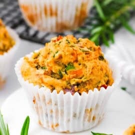 Savory vegetable muffins, served on a white plate.