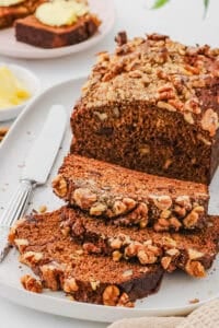 Vegan protein banana bread, sliced and served on a white plate.