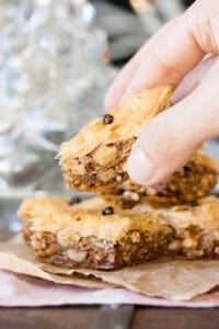 Vegan baklava being held up by a woman's hand.