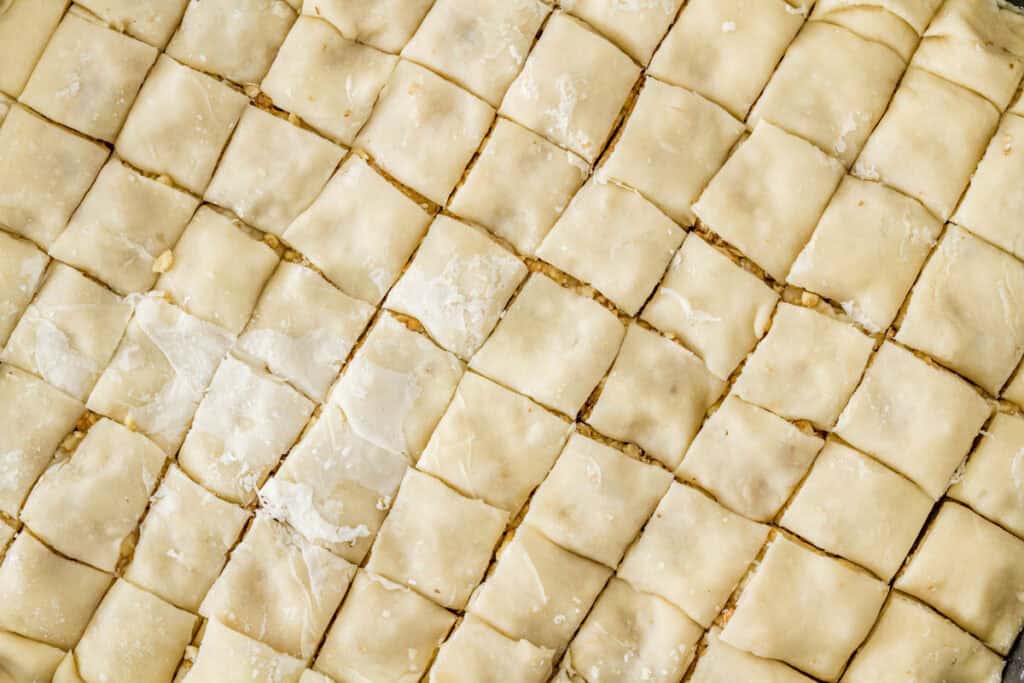 Vegan, oil free baklava being cut into squares.