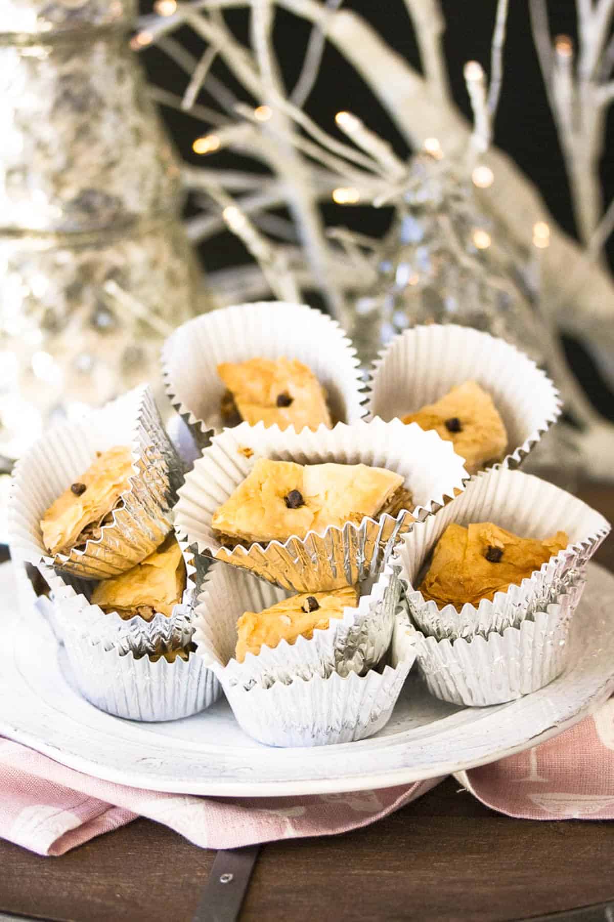 Vegan baklava served in cupcake liners on a countertop.