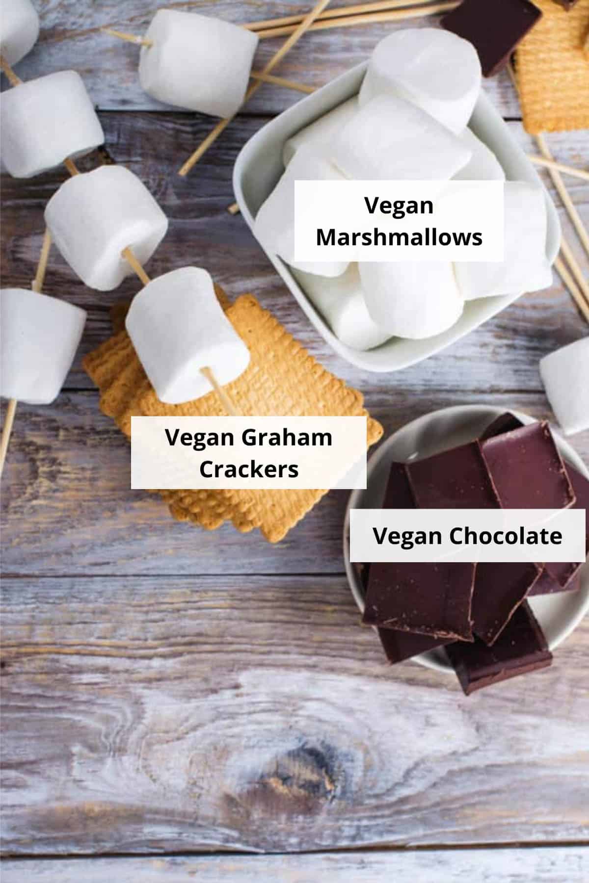 Ingredients for easy vegan s'mores on a wood background.