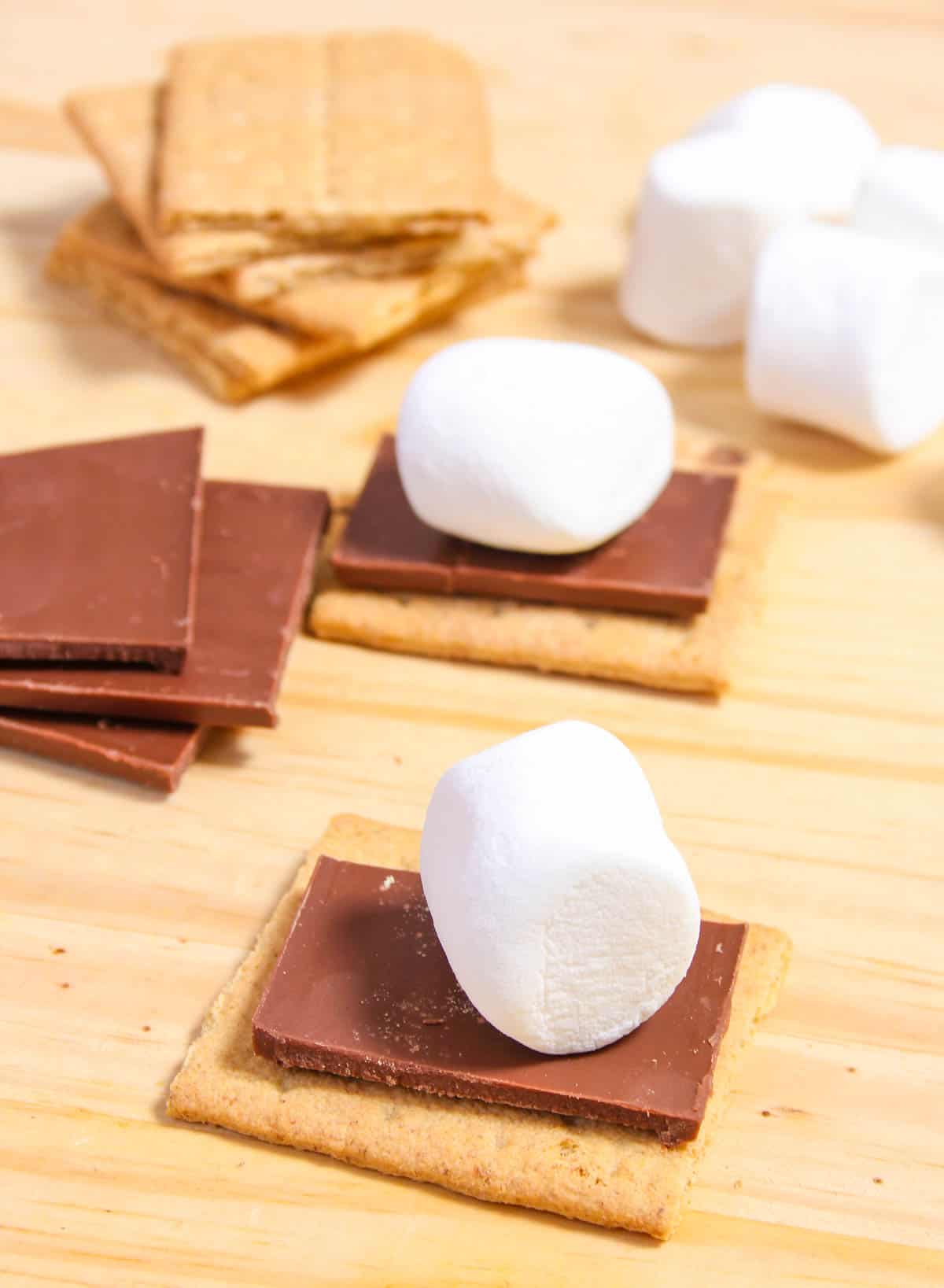 Graham cracker stacked with chocolate and a marshmallow.