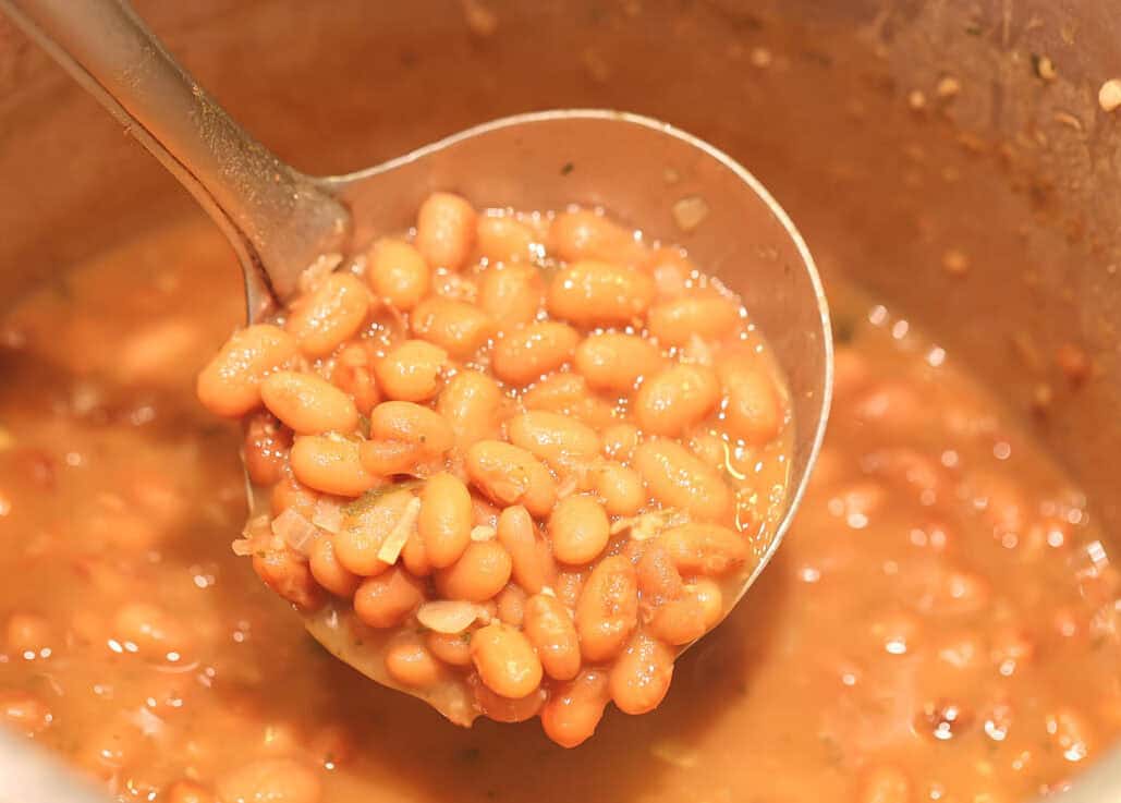 Vegan pinto beans in a pot on the stove.