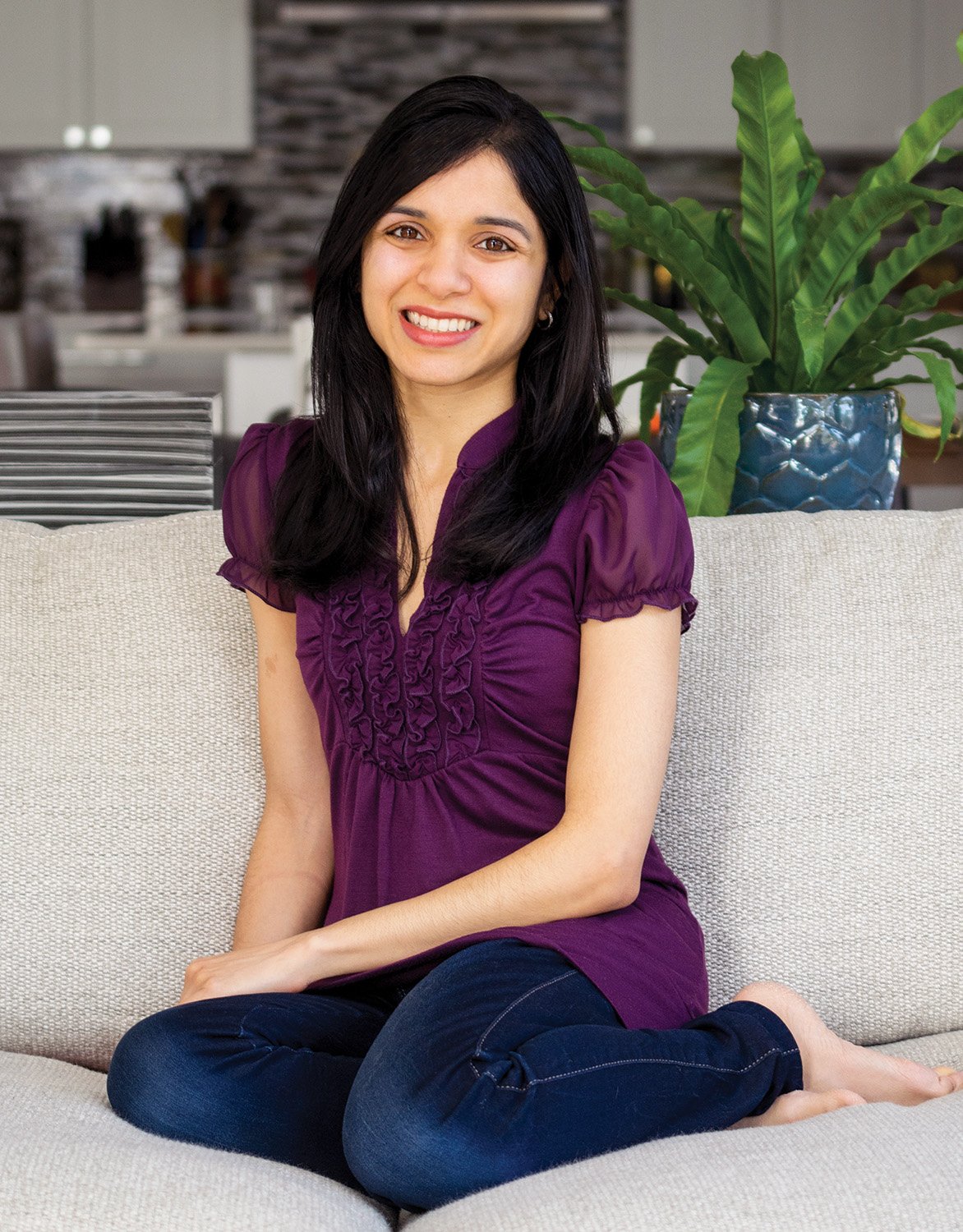 Photo of Anjali Shah on a couch.