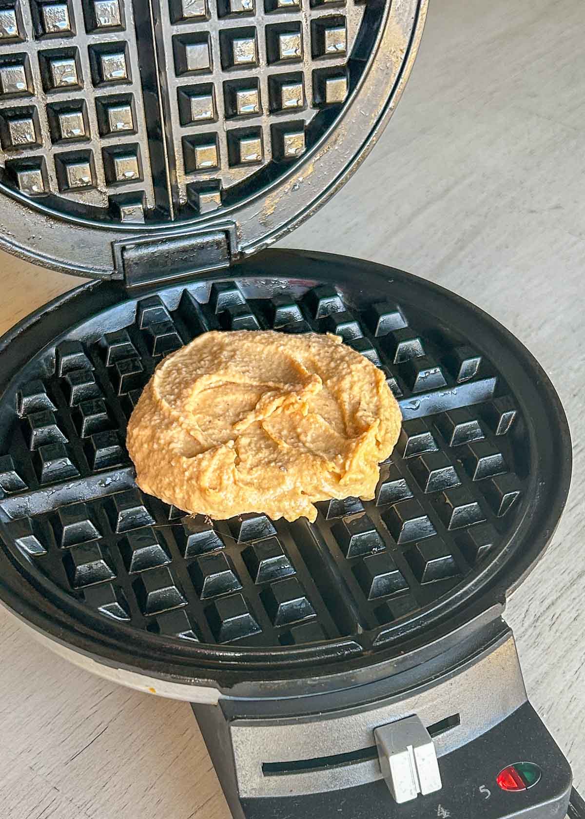 Waffle batter on waffle iron.