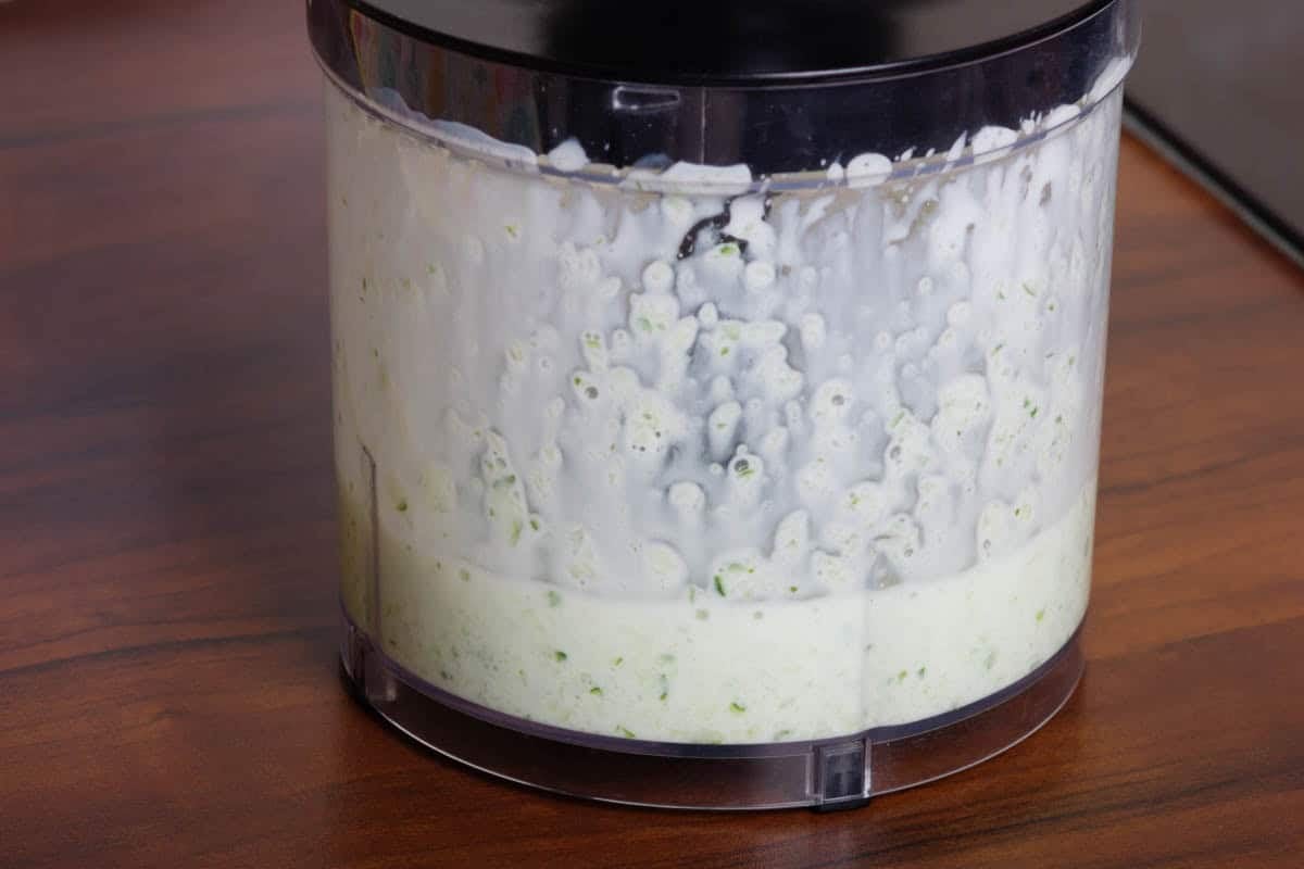 Yogurt and cucumber blended in a food processor.