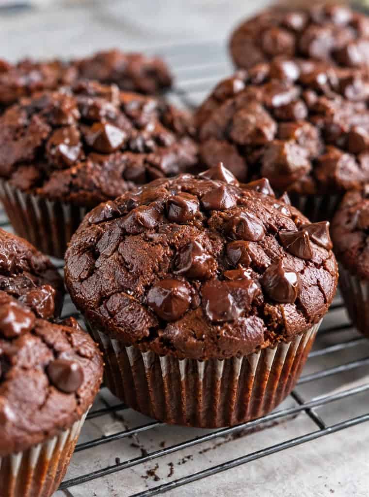 Chocolate sweet potato muffins cooling on a wire rack.